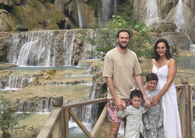 Ryan Blackley and wife Jess with sons Noah and Bodhi in Thailand by a waterfall.