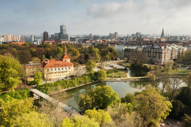 Aerial view of a large green park in the middle of a big city. Slottsparken is centrally located in Malm??.